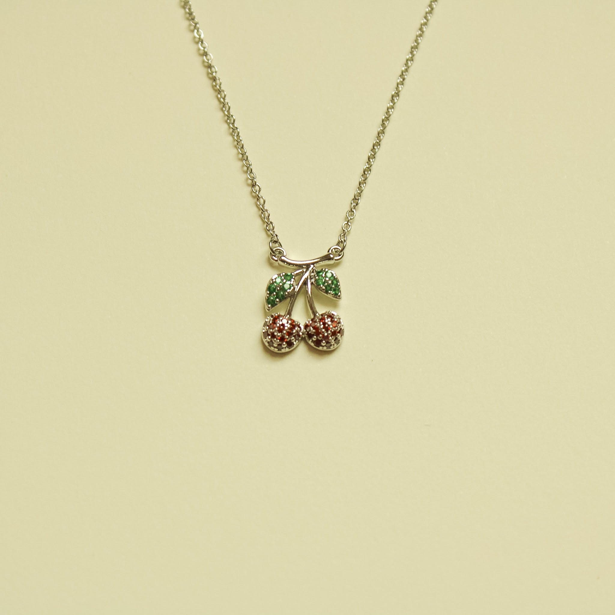 Pavé CZ Cherry Pendant Necklace Silver — full necklace flat lay alternate angle