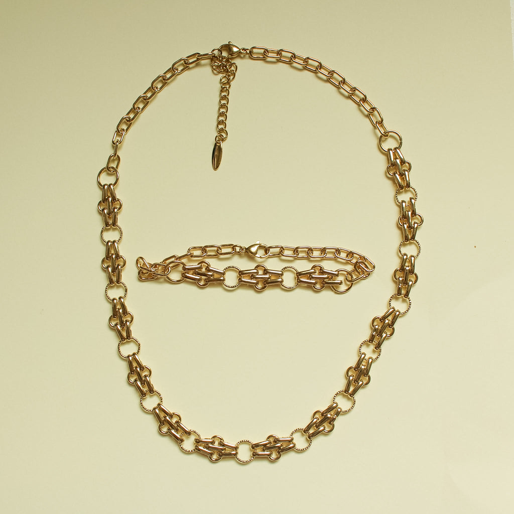 Gold-plated chain link necklace and bracelet set with teardrop charm and clasp