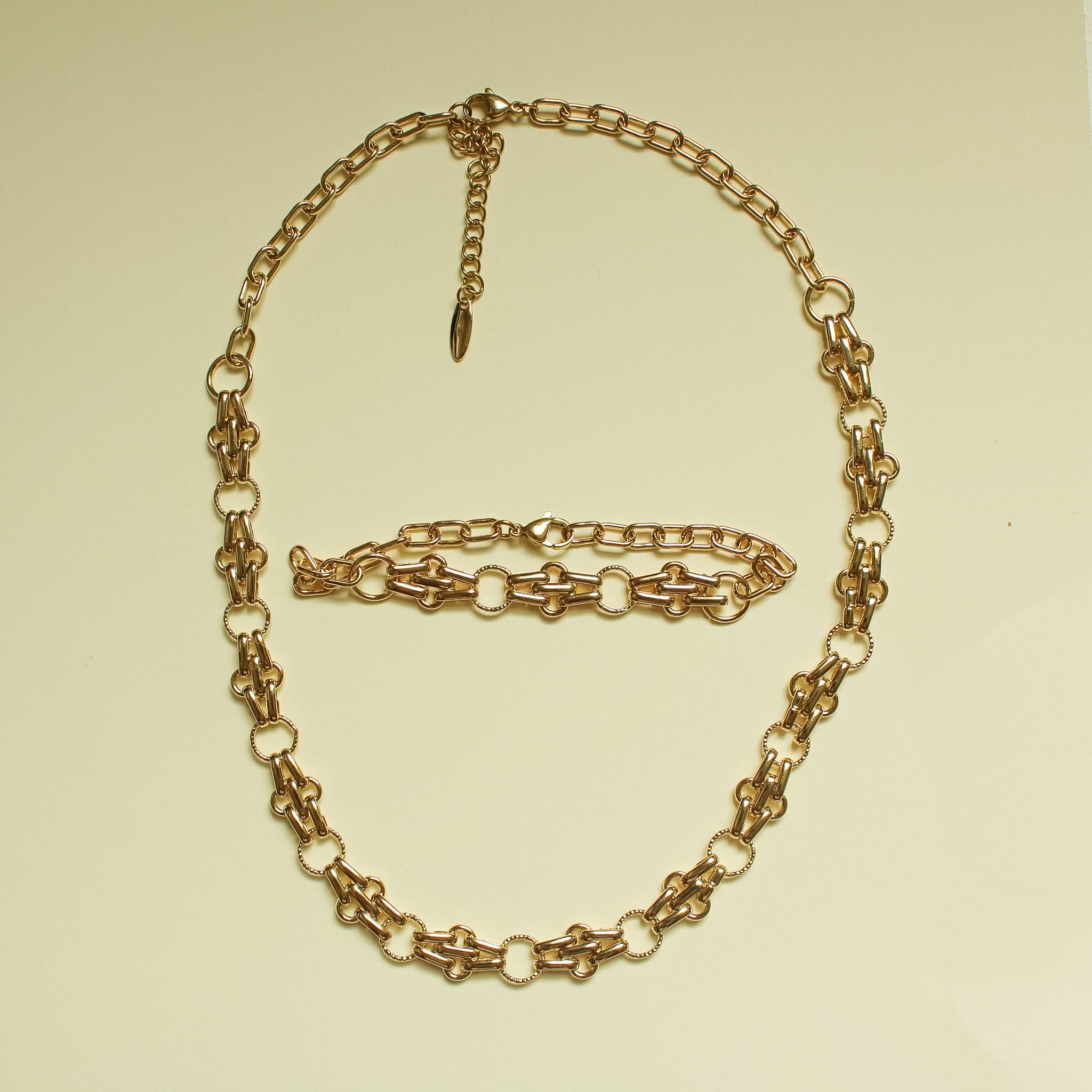 Gold-plated chain link necklace and bracelet set with teardrop charm and clasp