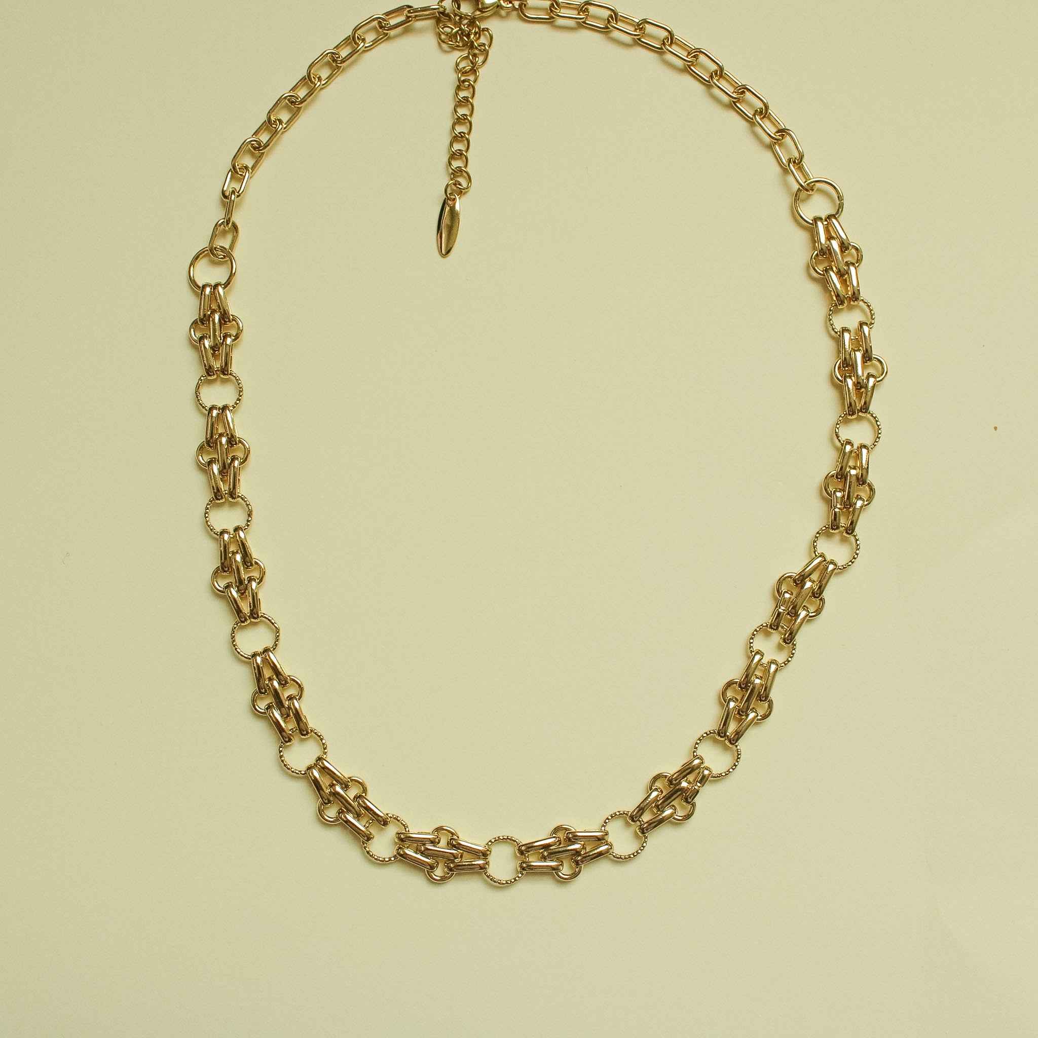 Gold-plated chain link necklace with matching bracelet, small teardrop charm drop