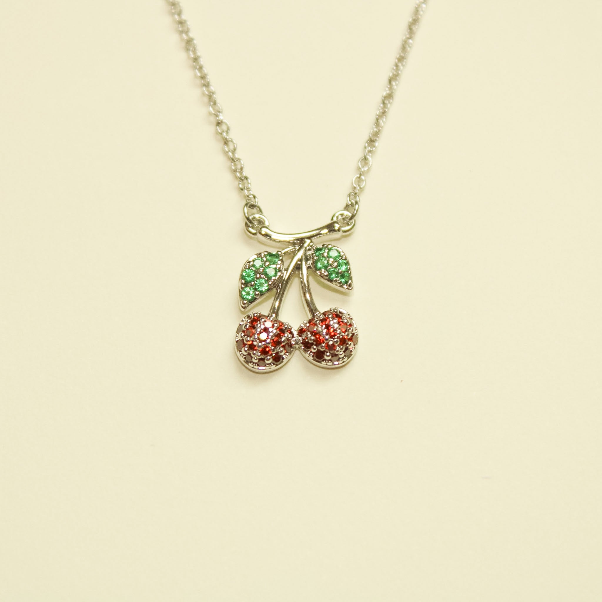 Pavé CZ Cherry Pendant Necklace Silver — cherry charm close-up showing red and green CZ detail