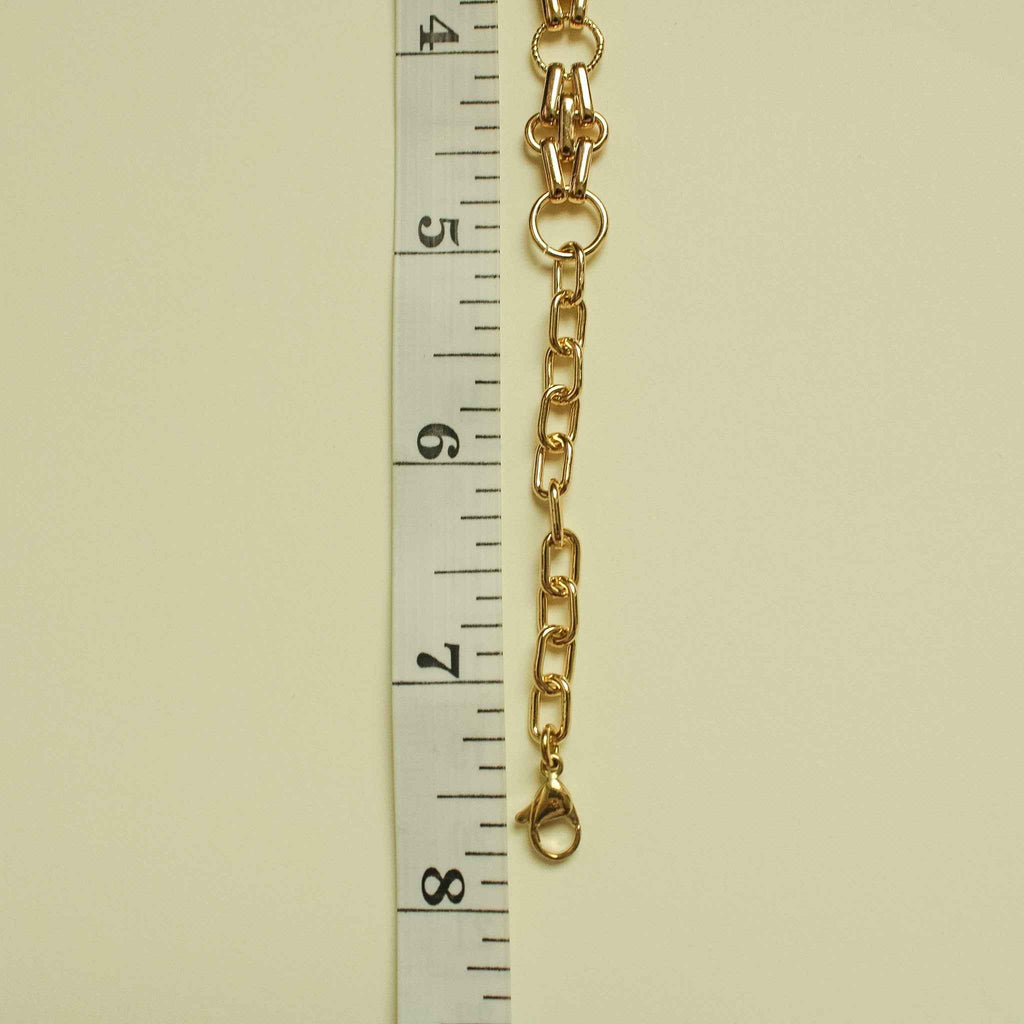 Gold-plated chain bracelet with interlocking oval links and small teardrop charm
