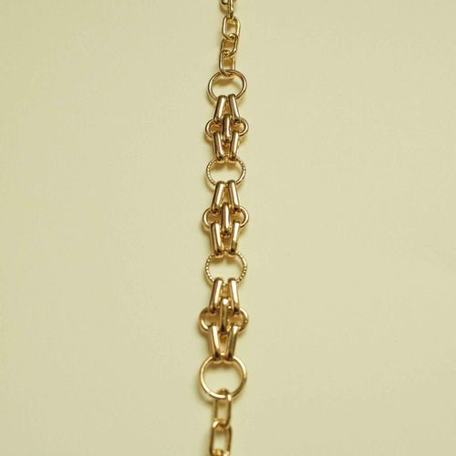 Gold-plated chain segment with clasp loop and oval rings, bracelet detail