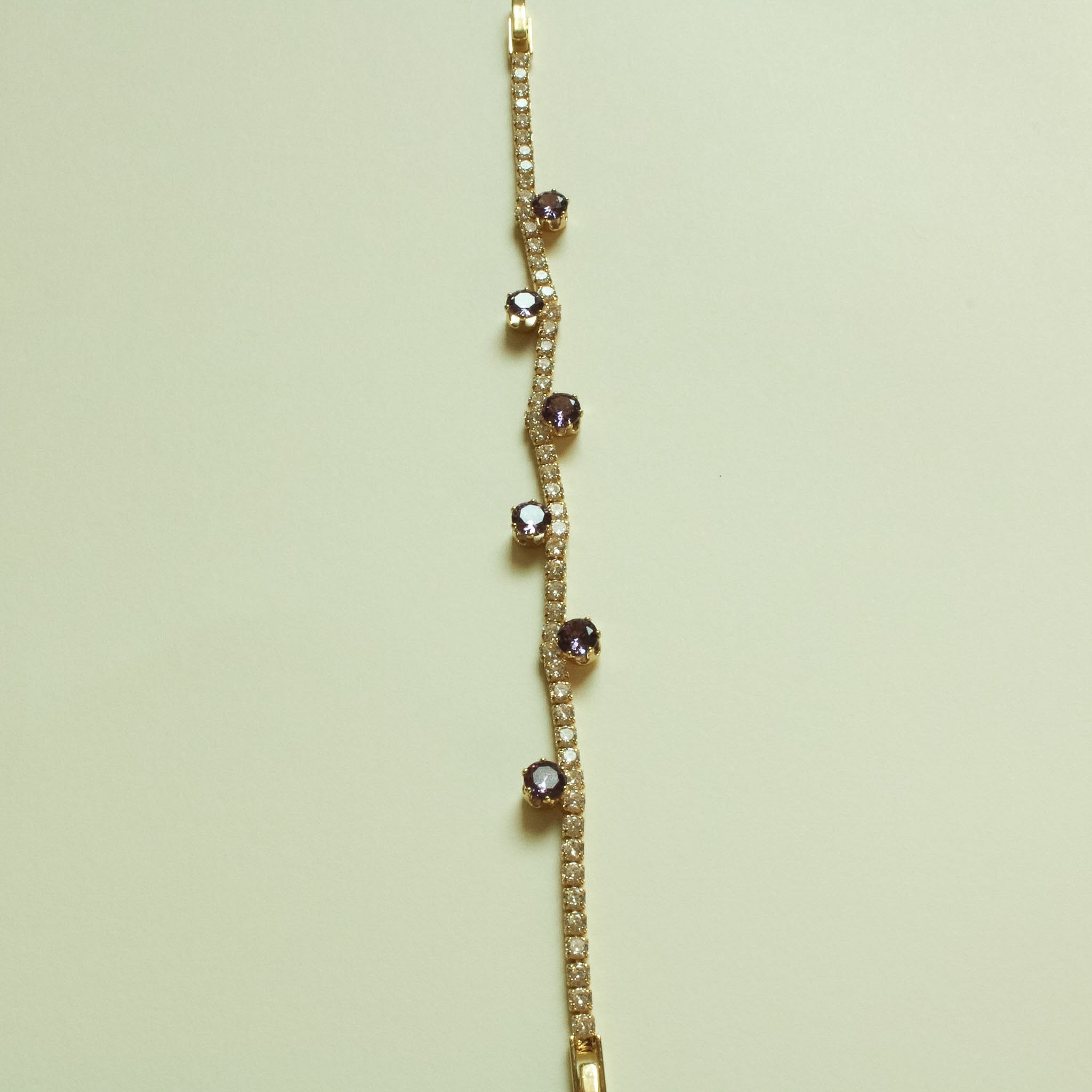 Gold-plated station tennis bracelet with purple round stones