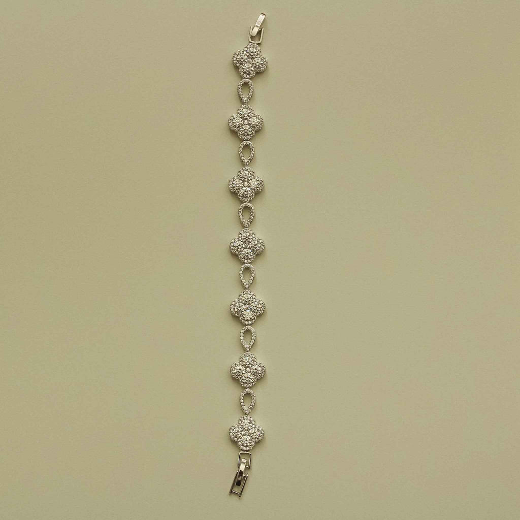 Silver-tone CZ clover bracelet strand with teardrop links and metal clasp end