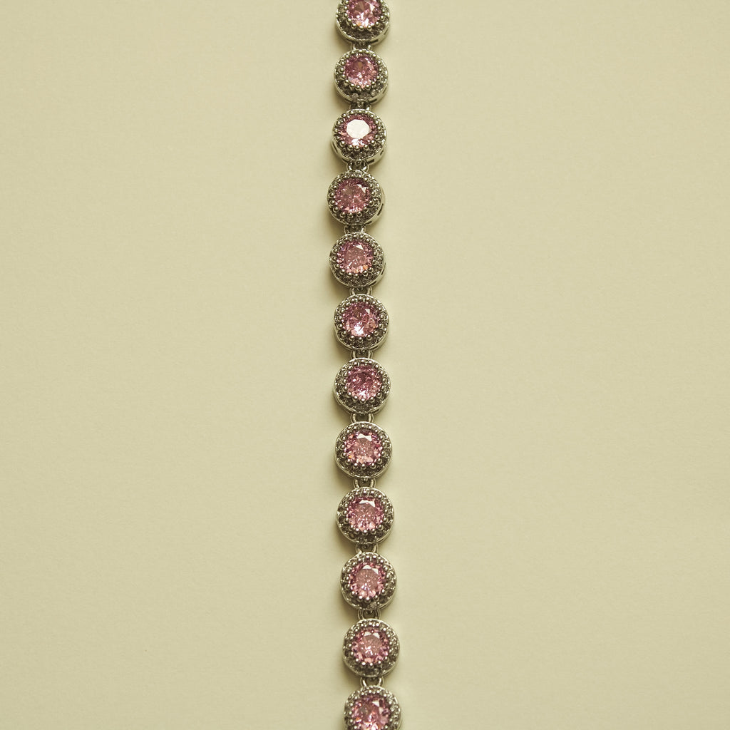 Pink halo CZ tennis bracelet, vertical view of linked round bezel-set stones