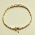 Gold-tone tennis bracelet with graduated clear crystal stones and hook clasp