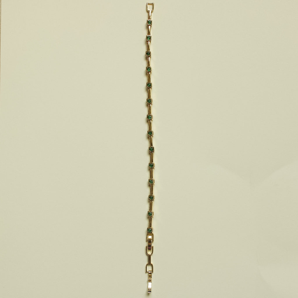 Gold-tone bracelet chain with slim rectangular links and green accents