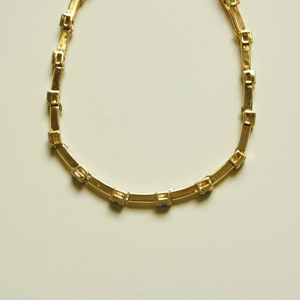 Gold-tone bar link bracelet, side view showing rectangular settings