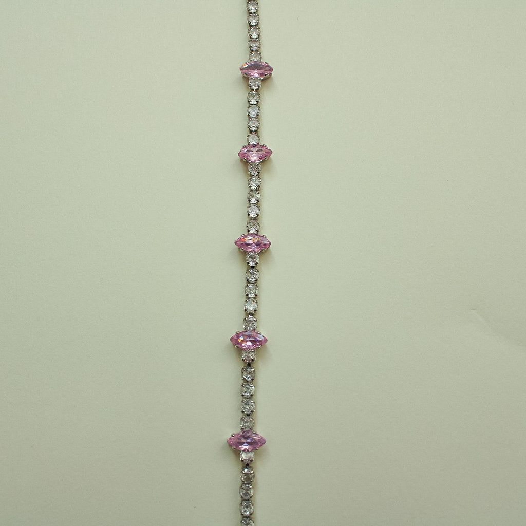 Pink marquise CZ tennis bracelet with repeating pink stones along a pavé band