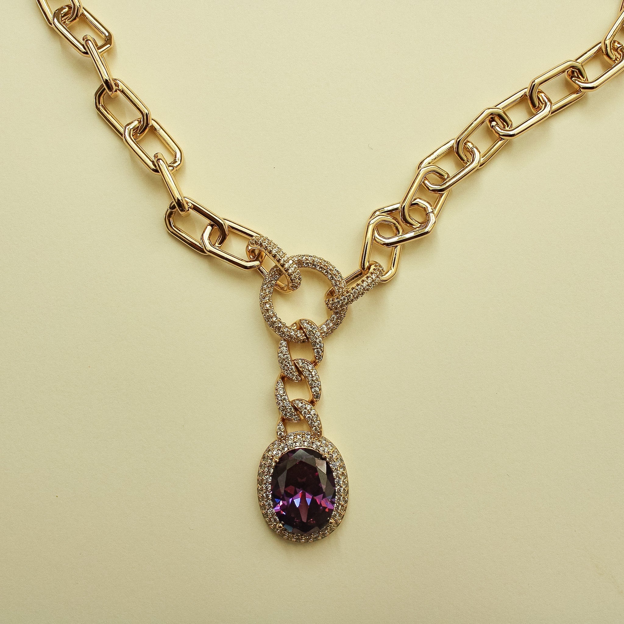 Gold paperclip chain necklace with purple gemstone drop pendant, crystal bezel
