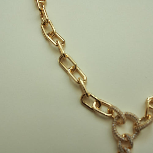 Gold paperclip chain necklace with purple gemstone pendant detail