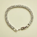 Double-row CZ tennis bracelet with clear baguette stones and box clasp, silver-tone