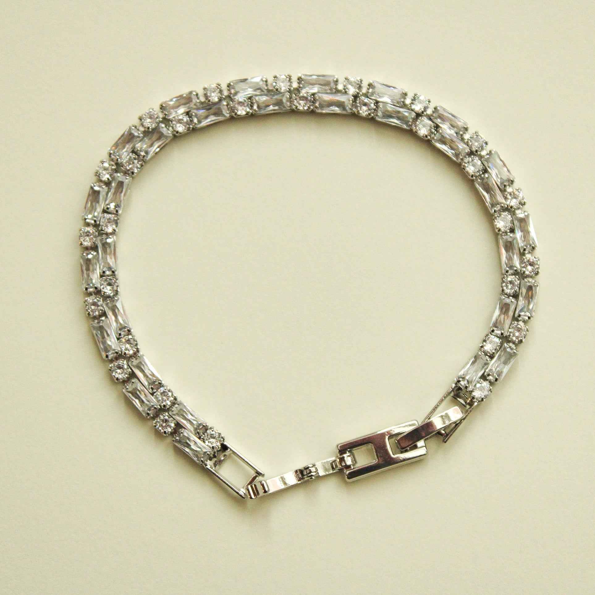 Double-row CZ tennis bracelet with clear baguette stones and box clasp, silver-tone