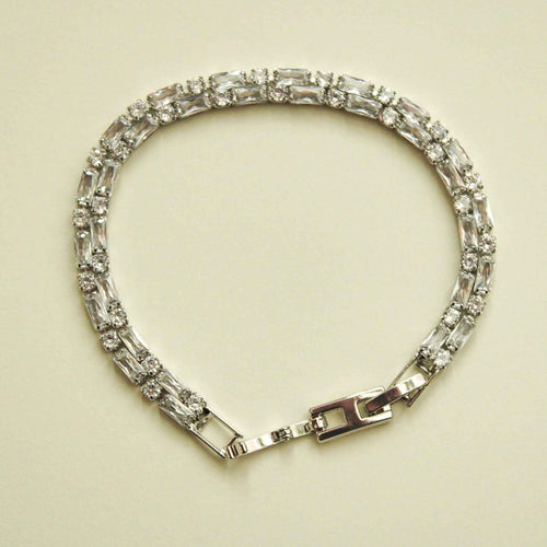 Double-row CZ tennis bracelet with clear baguette stones and box clasp, silver-tone
