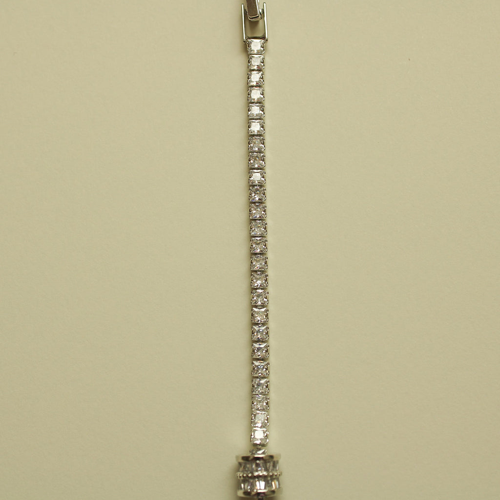 Silver tennis bracelet with continuous row of round clear stones and small end caps
