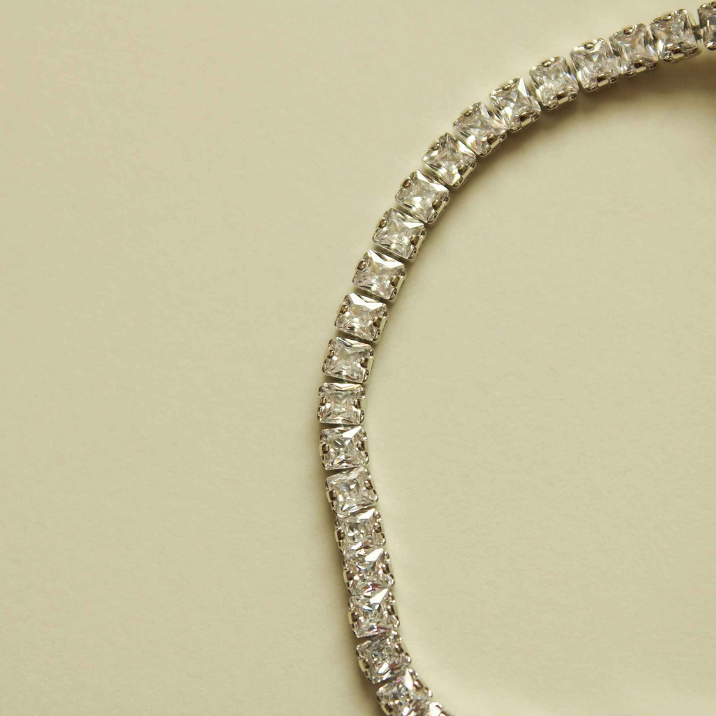 Silver tennis bracelet section with sparkling round clear stones in metal setting