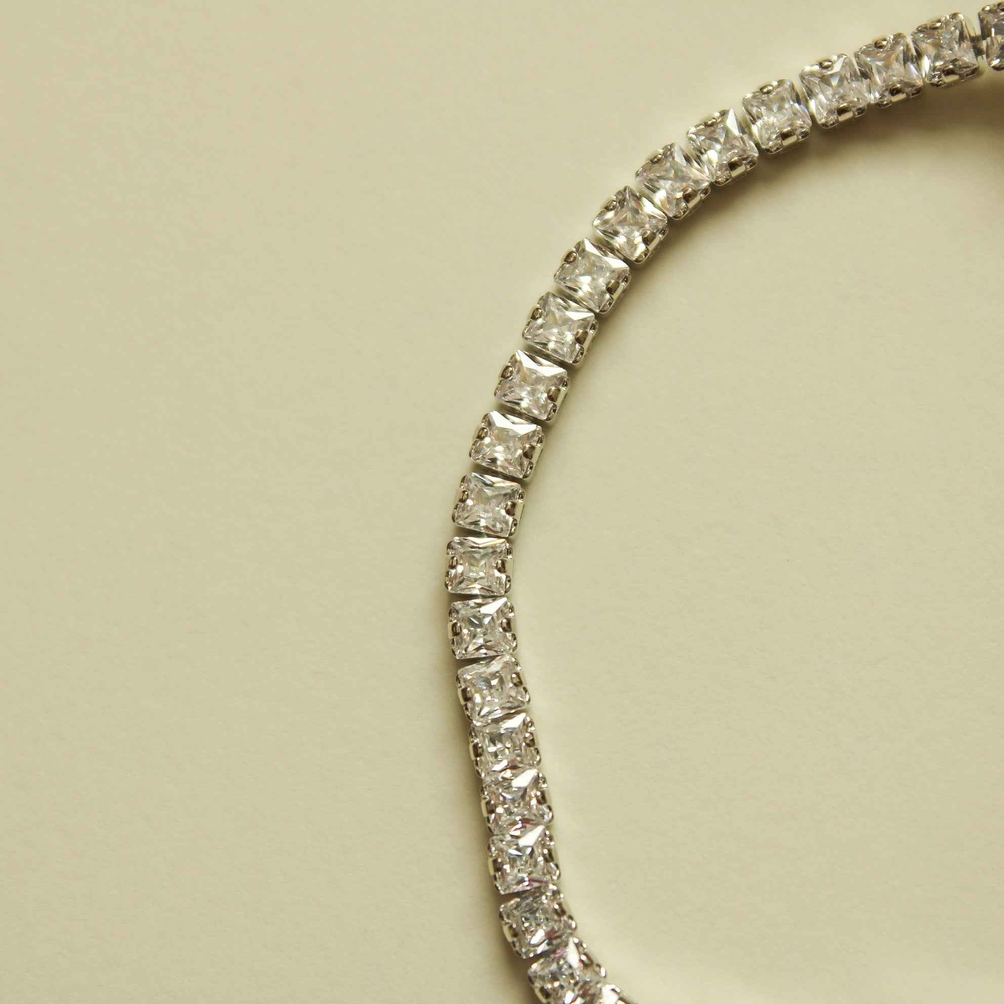 Silver tennis bracelet section with sparkling round clear stones in metal setting