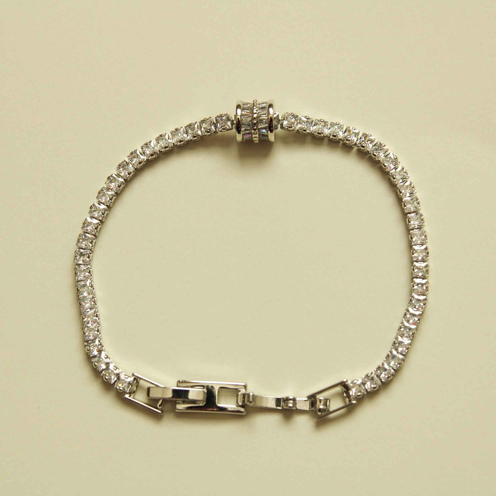 Silver tennis bracelet with round clear stones and baguette station links, box clasp