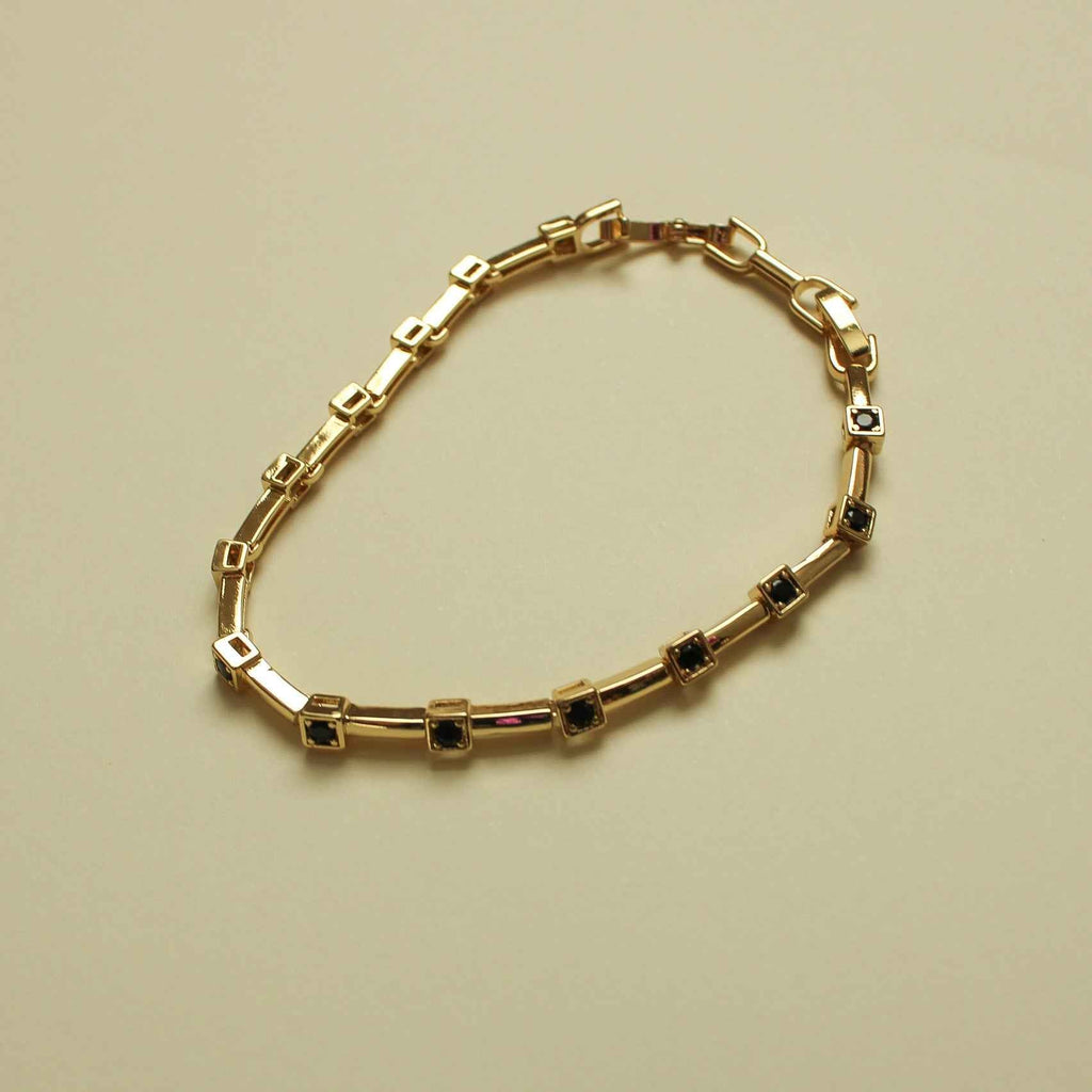 Gold station bracelet with black CZ bezels in rectangular settings and clasp