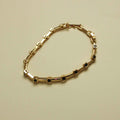 Gold station bracelet with black CZ bezels in rectangular settings and clasp