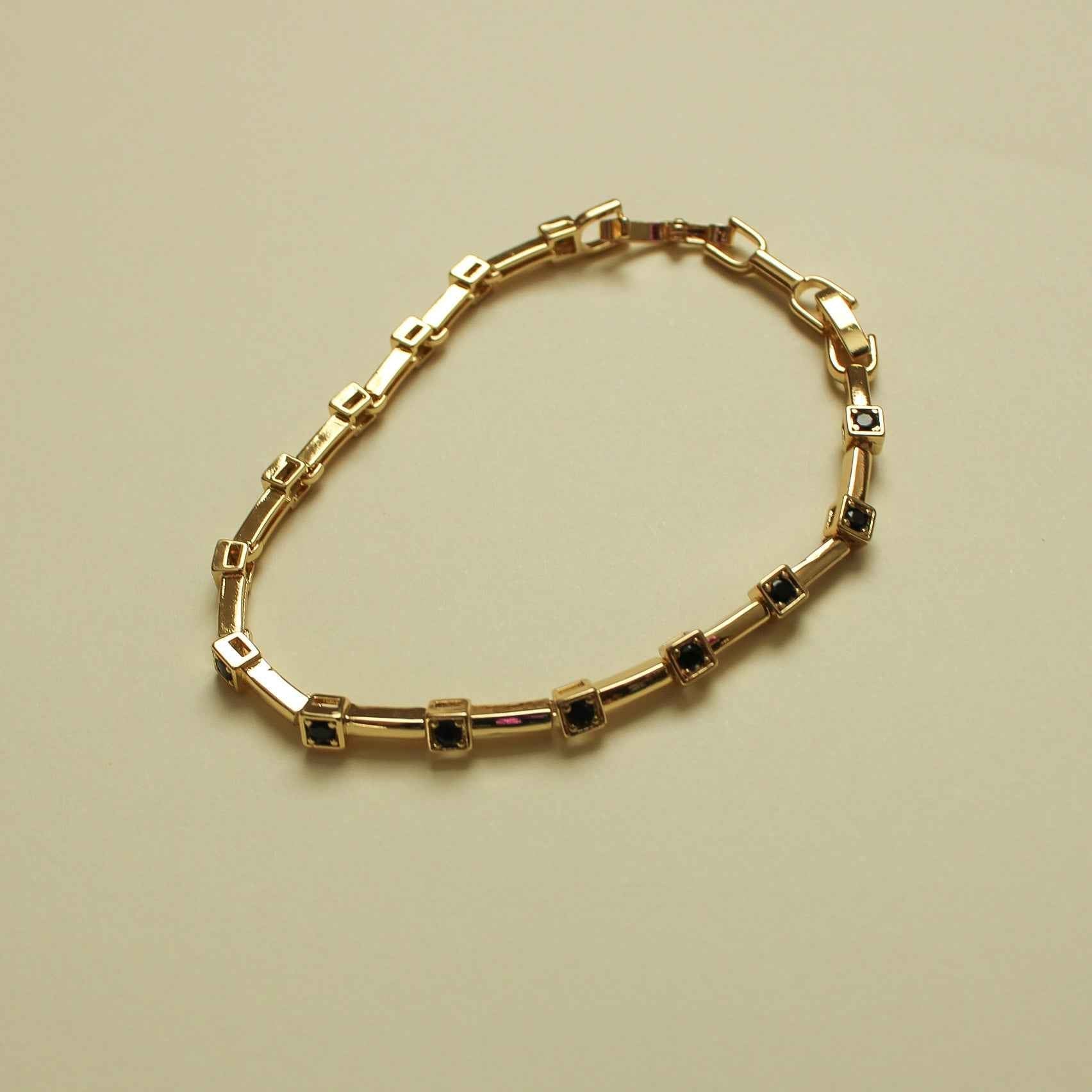 Gold station bracelet with black CZ bezels in rectangular settings and clasp