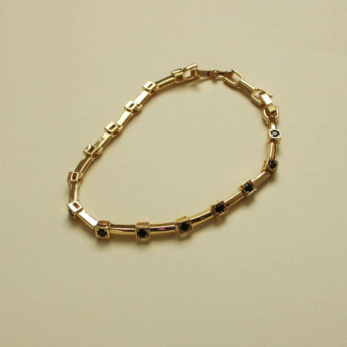 Gold station bracelet with black CZ bezels in rectangular settings and clasp