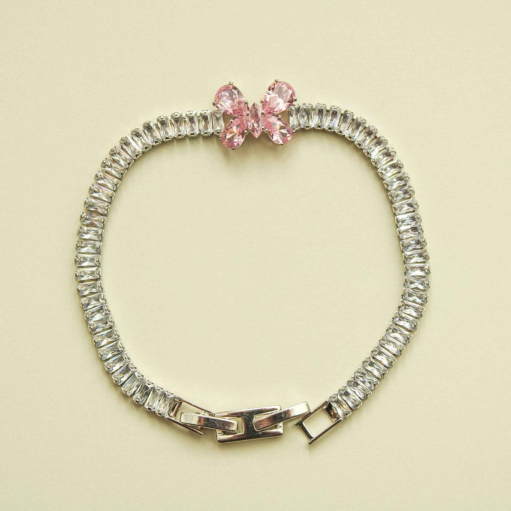 Silver CZ baguette bracelet with pink butterfly bow and hinged clasp