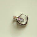 Silver hoop huggie earring with pink and clear rectangular stones, side view