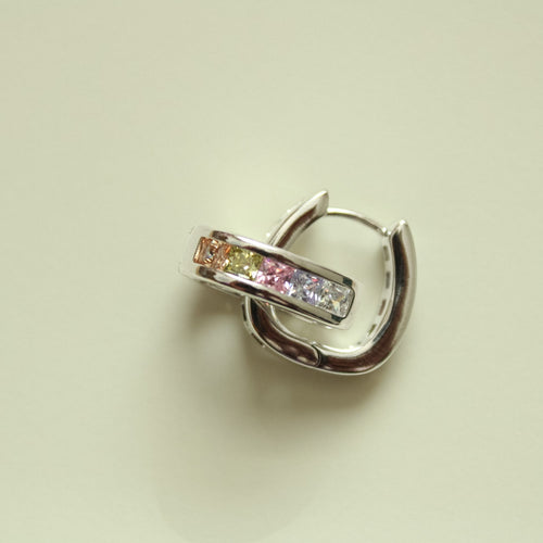 Silver hoop huggie earring with pink and clear rectangular stones, side view