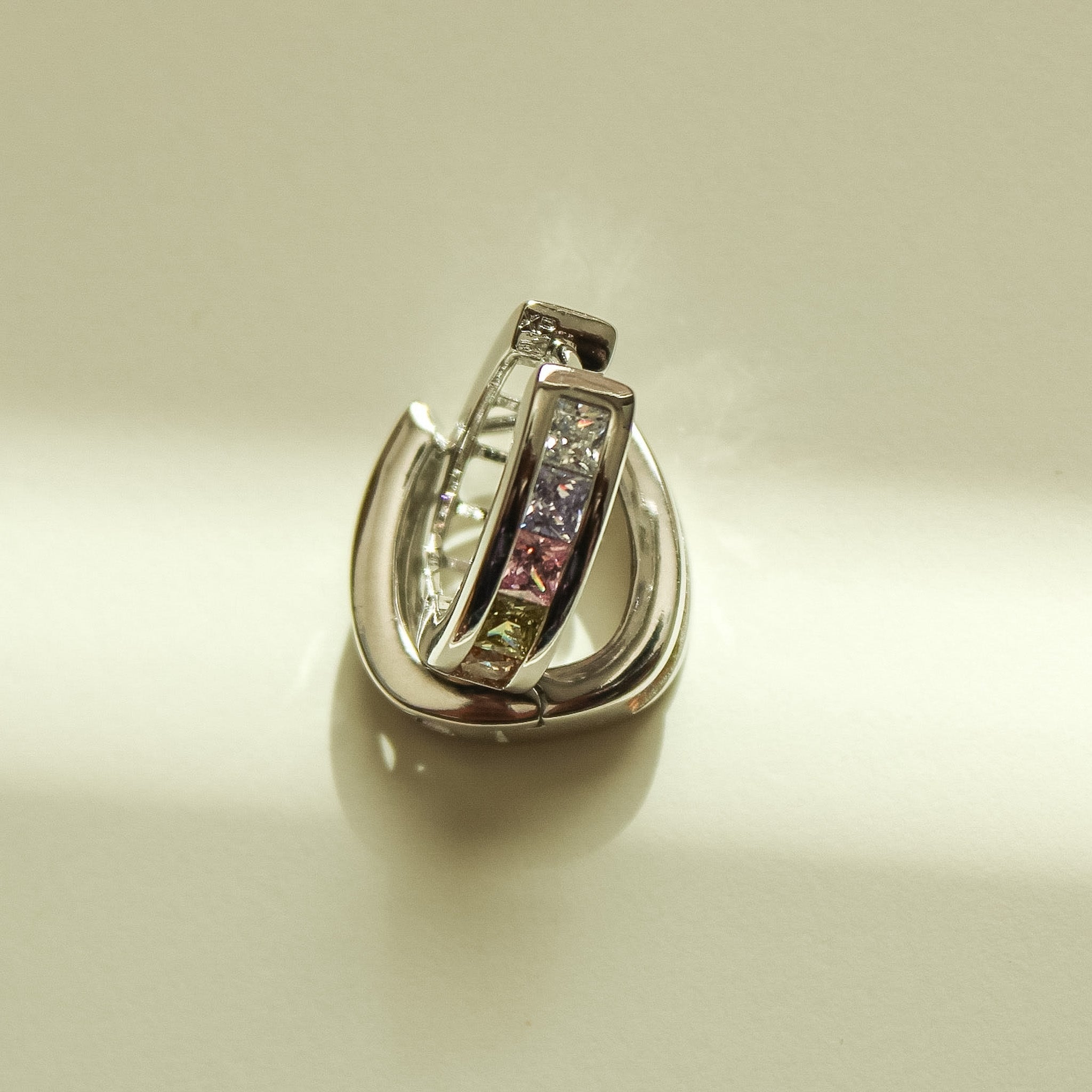 Silver hoop huggie earrings with rectangular pink and clear stones