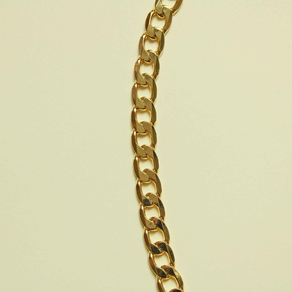 Chunky Cuban link 14K gold chain necklace, side view of thick polished links
