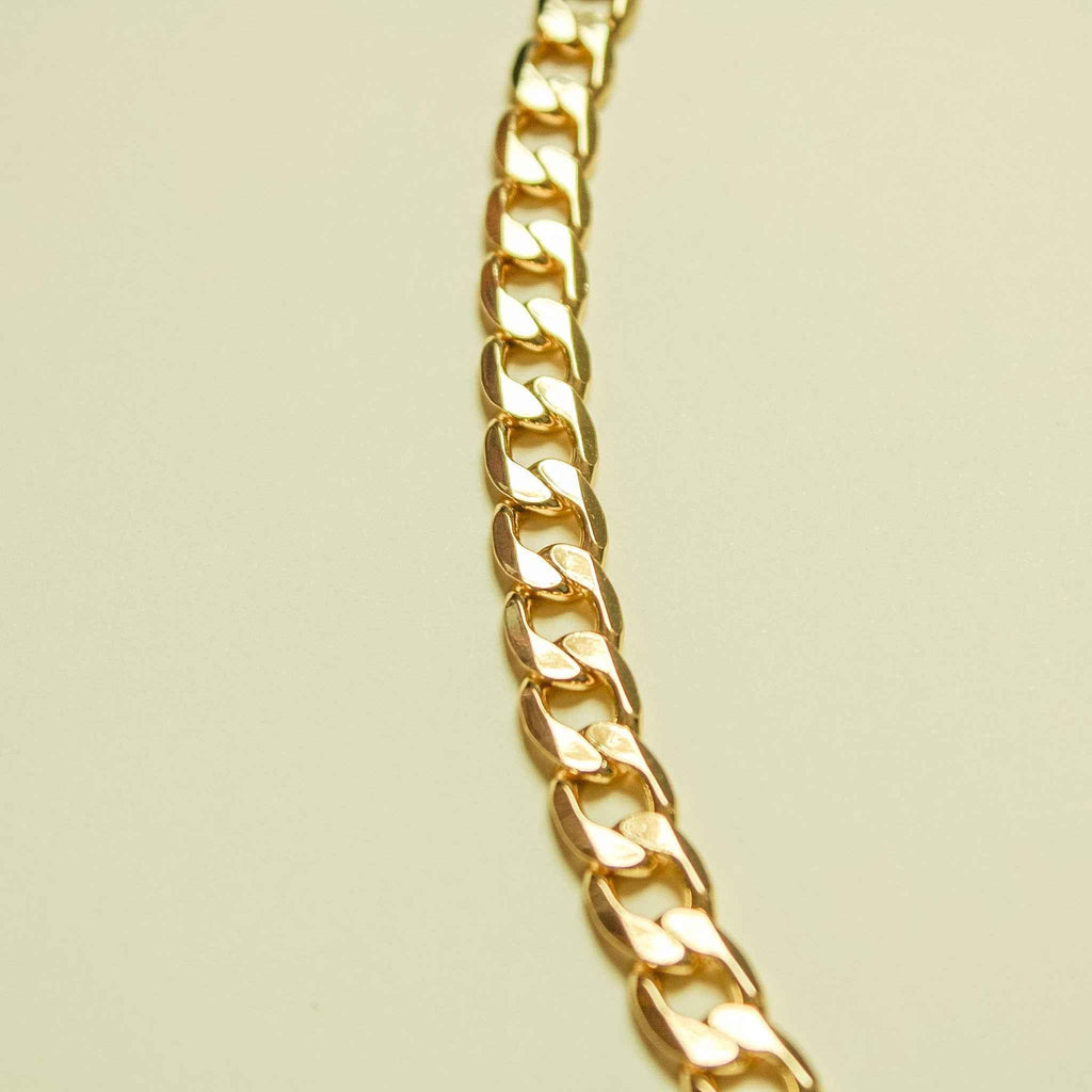 Chunky Cuban link 14K gold chain necklace, close-up side links with high shine