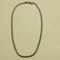 Chunky curb chain necklace arranged in an even loop of silver-tone links