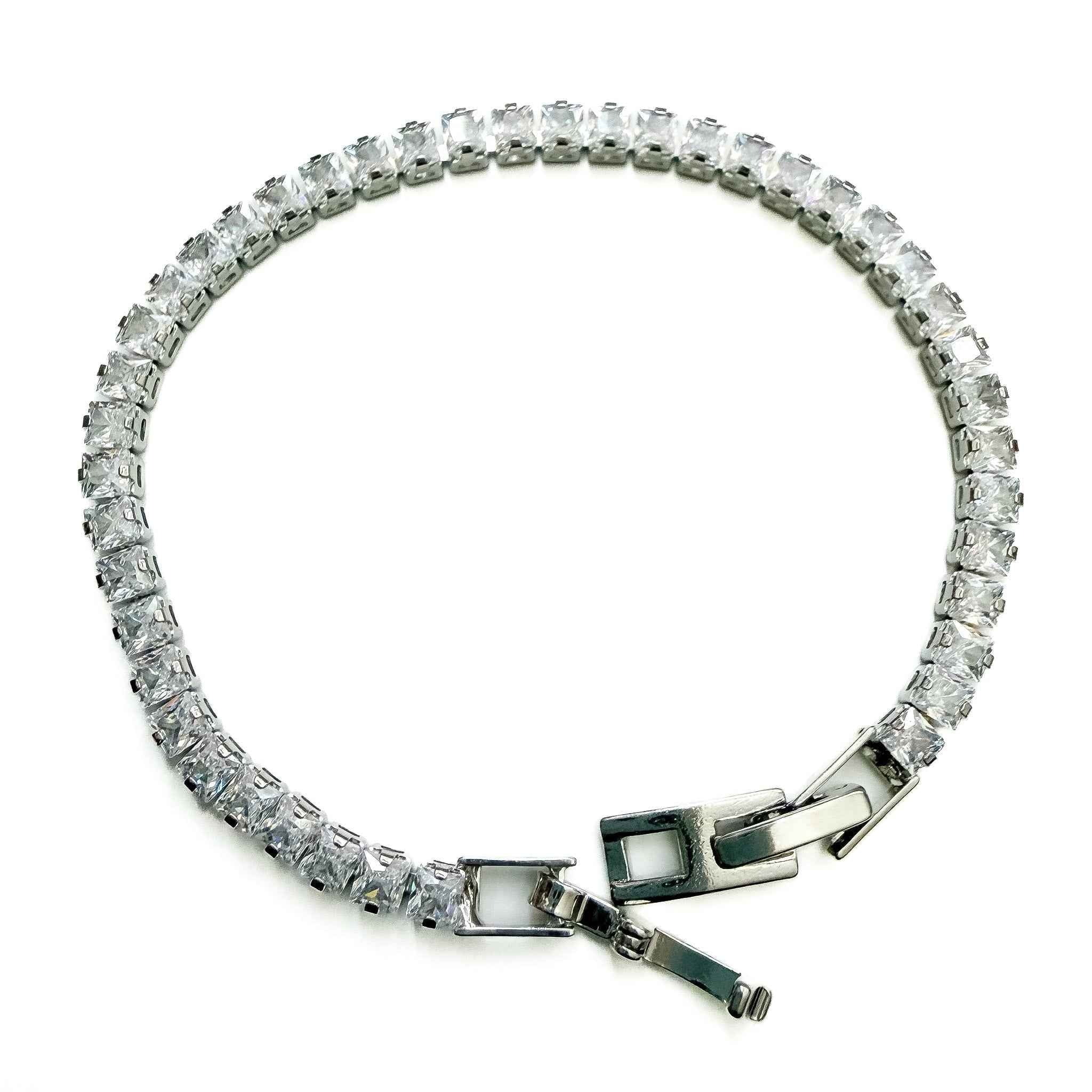 CZ tennis bracelet with clear stones and clasp with green enamel accents