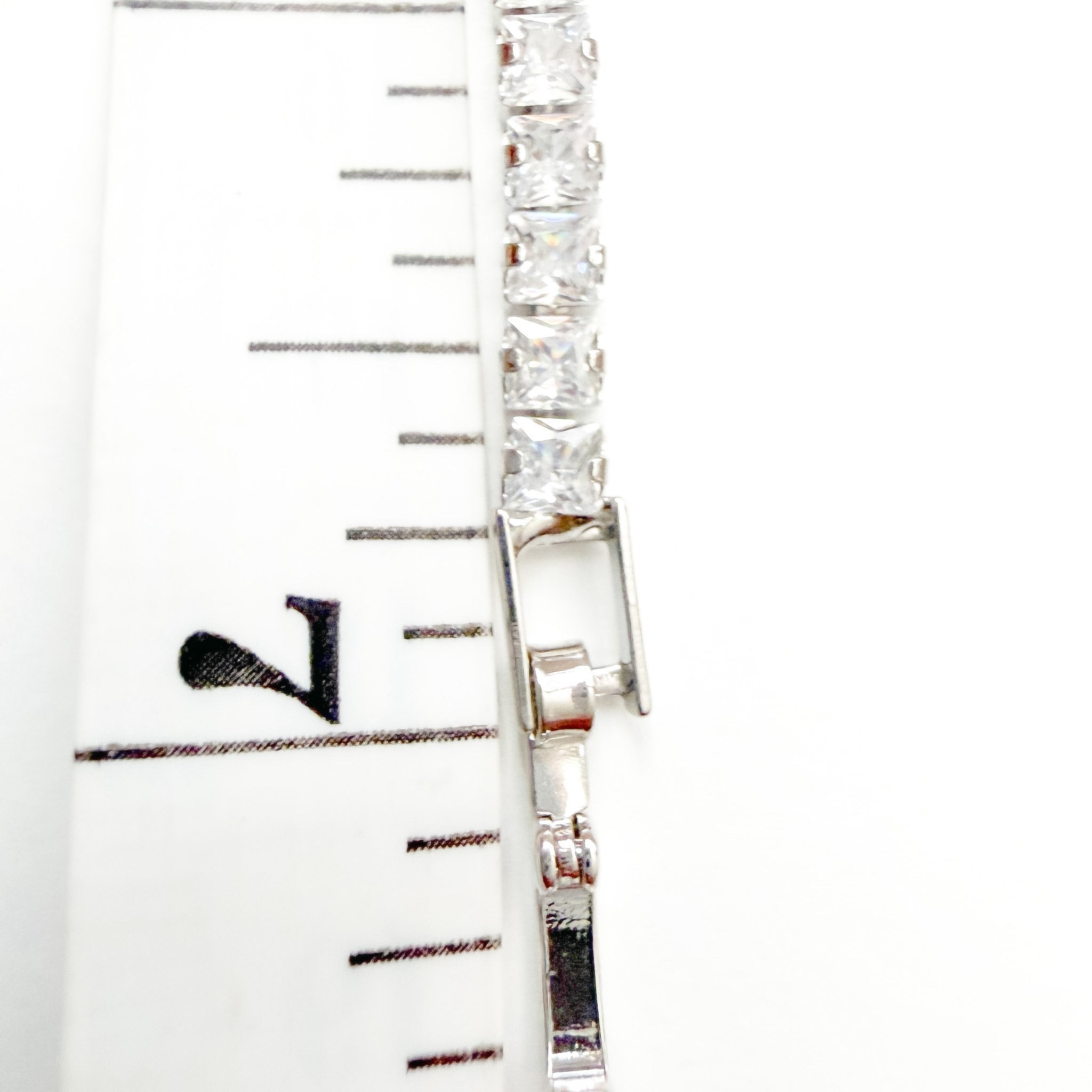 CZ tennis bracelet clasp with clear stones and metal bar detail