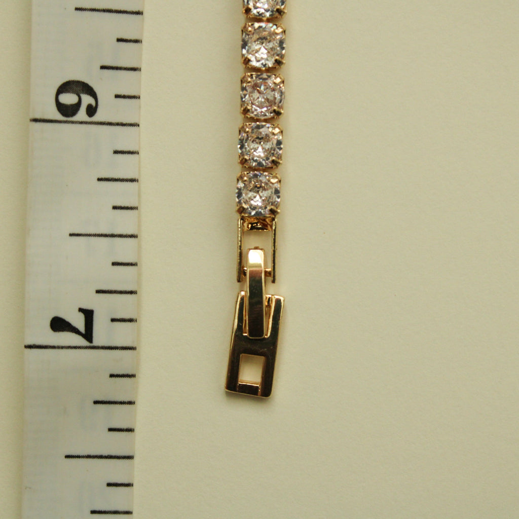 Gold-tone tennis bracelet clasp with clear CZ bezel stones and hinge closure