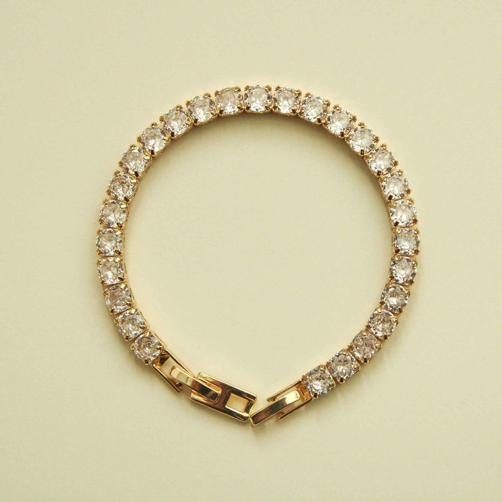 Gold-tone tennis bracelet with clear CZ stones and box clasp end links
