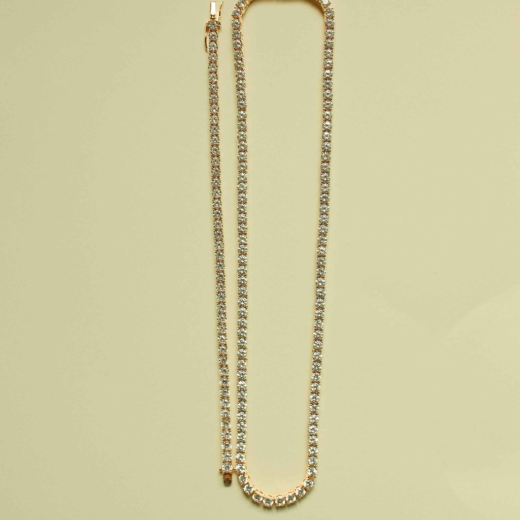 Rose gold-plated CZ tennis necklace laid in a U shape