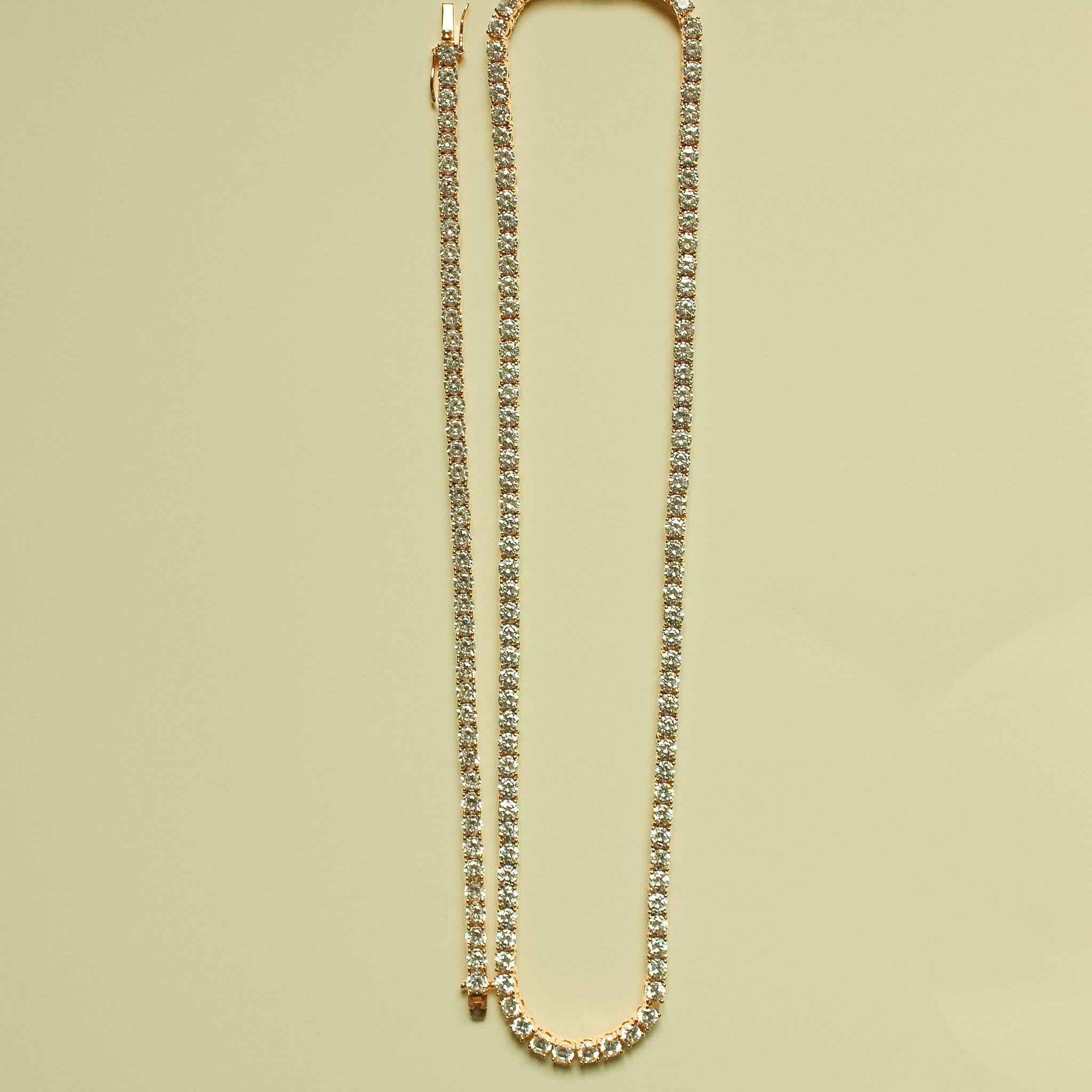 Rose gold-plated CZ tennis necklace laid in a U shape
