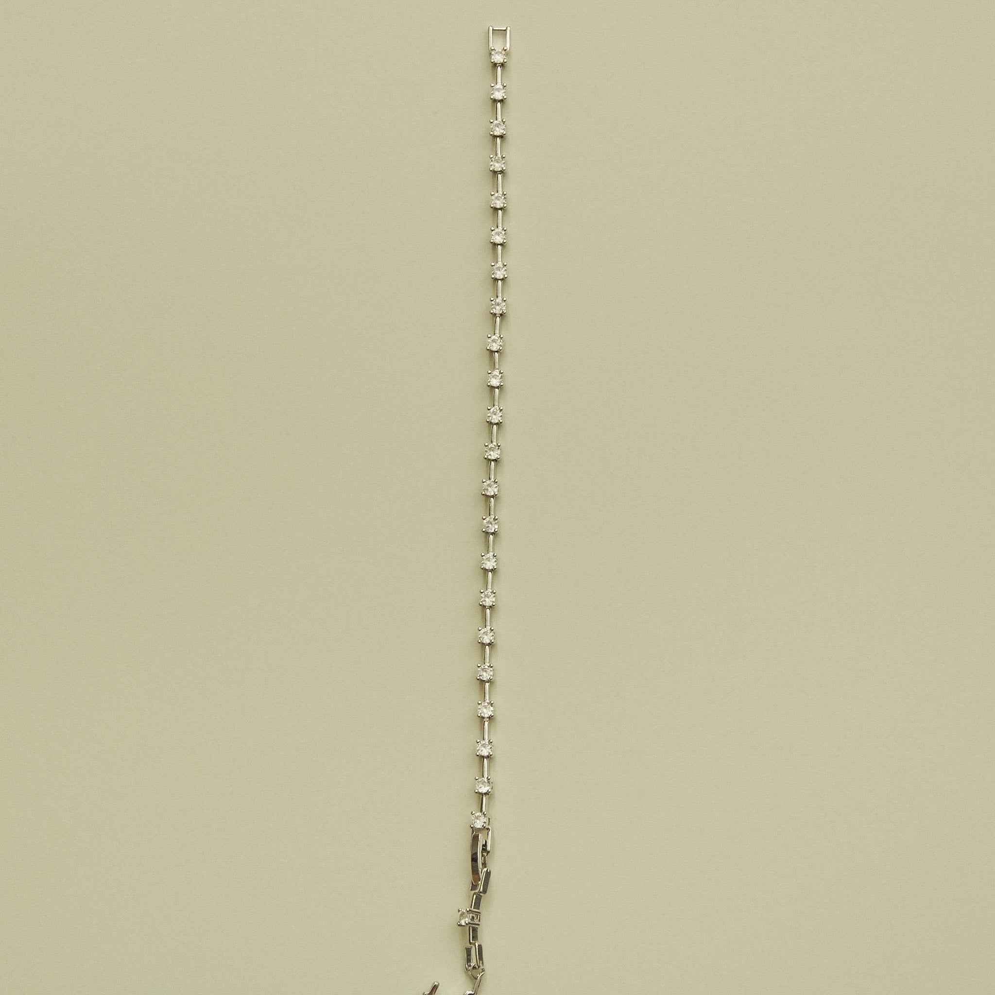 Clear CZ station bracelet with evenly spaced small round clear stones along the chain