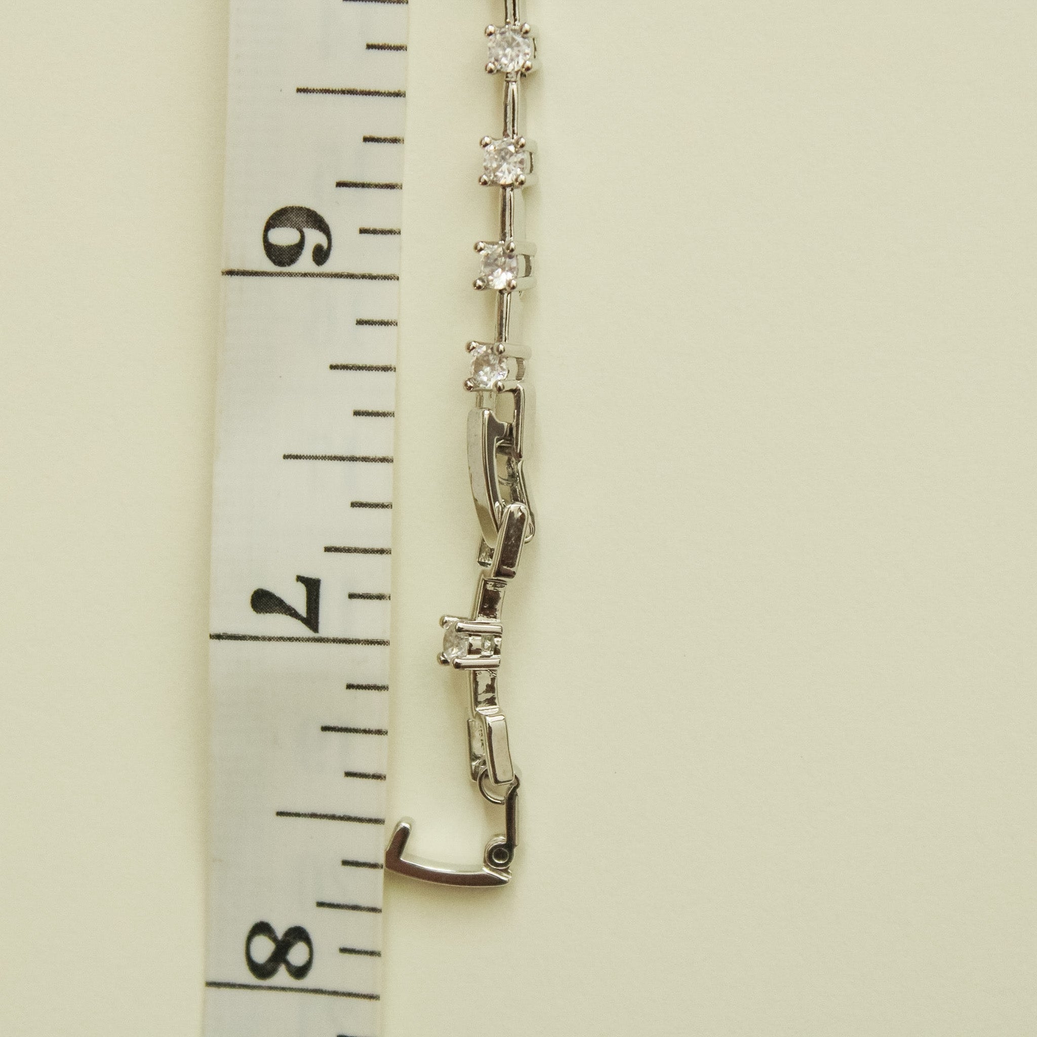 Clear CZ station bracelet clasp detail with round clear stones and hinged link segments