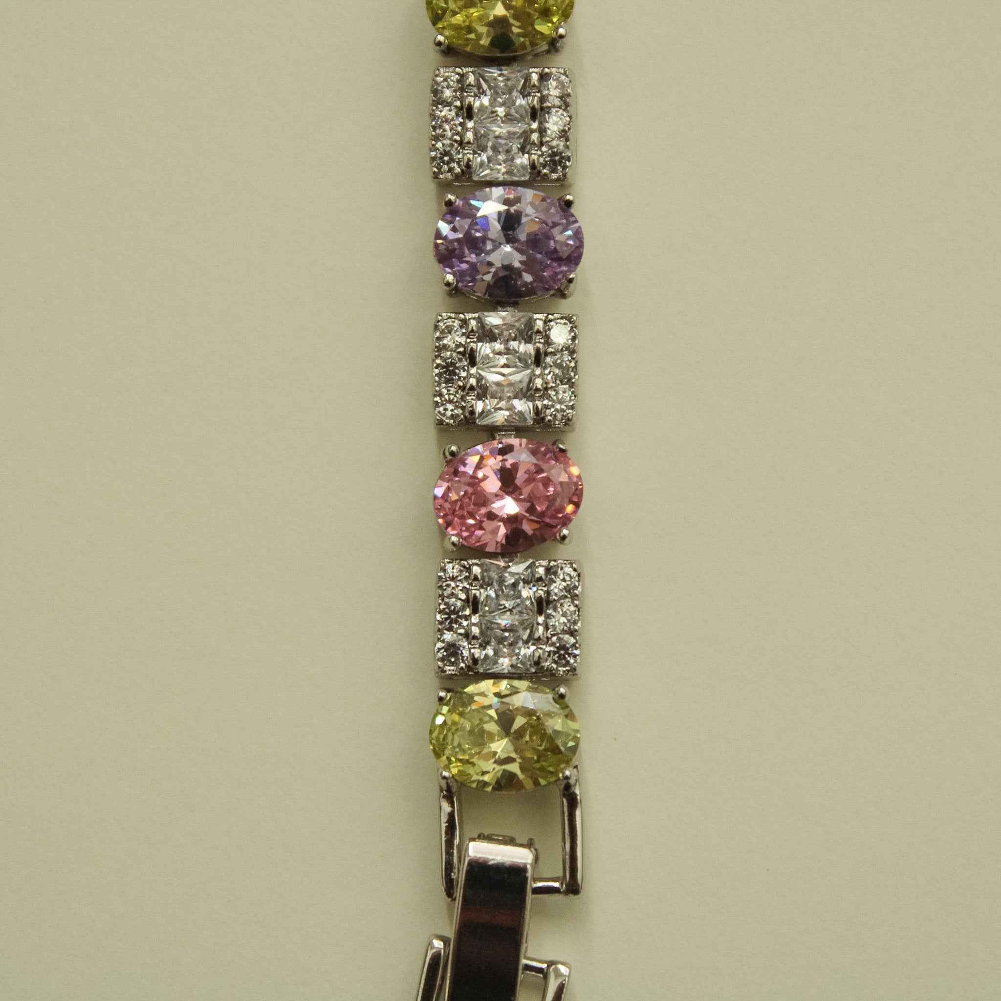CZ tennis bracelet link close-up with round multicolor stones and square pave settings