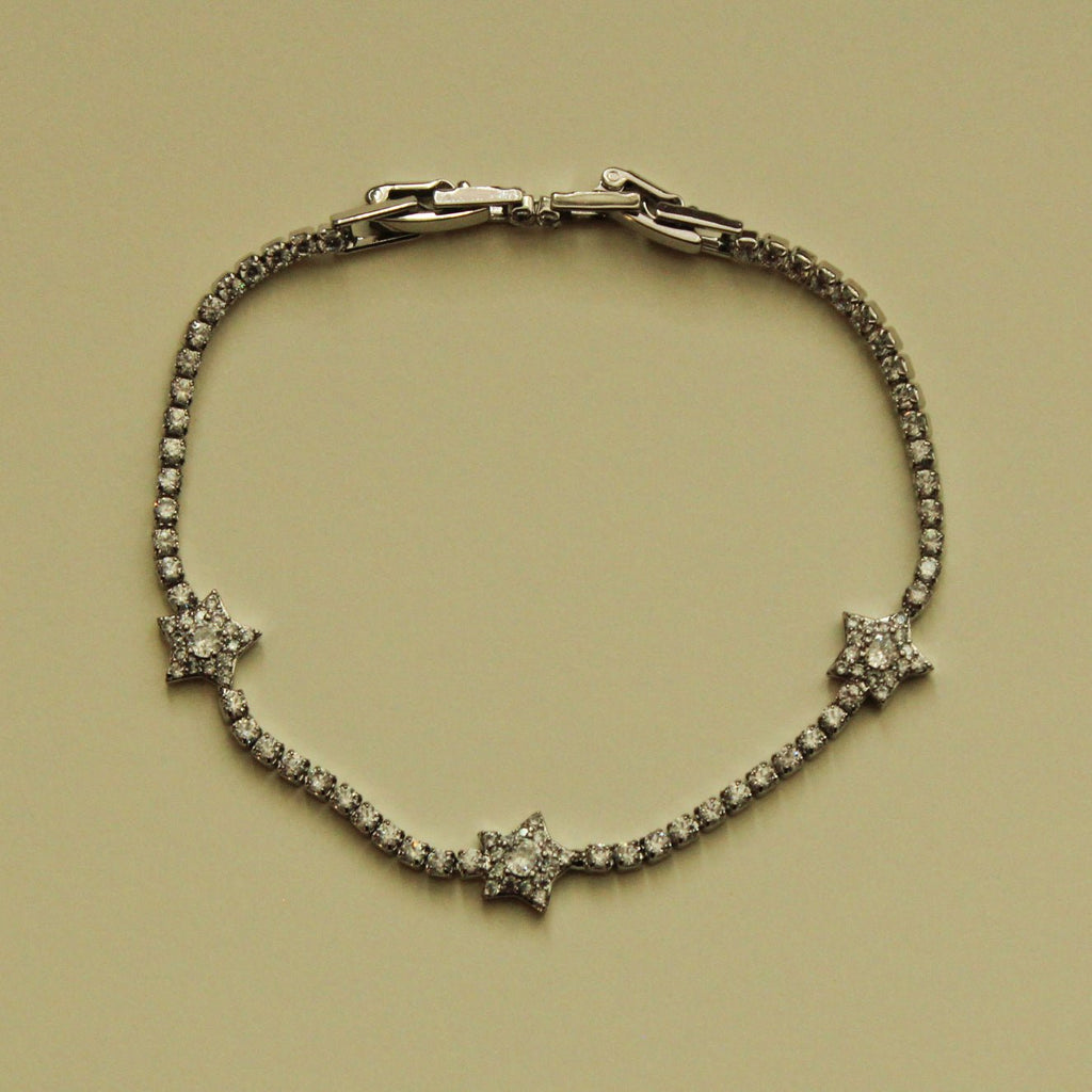 Silver-tone tennis bracelet with three clear CZ star accents and hinged clasp