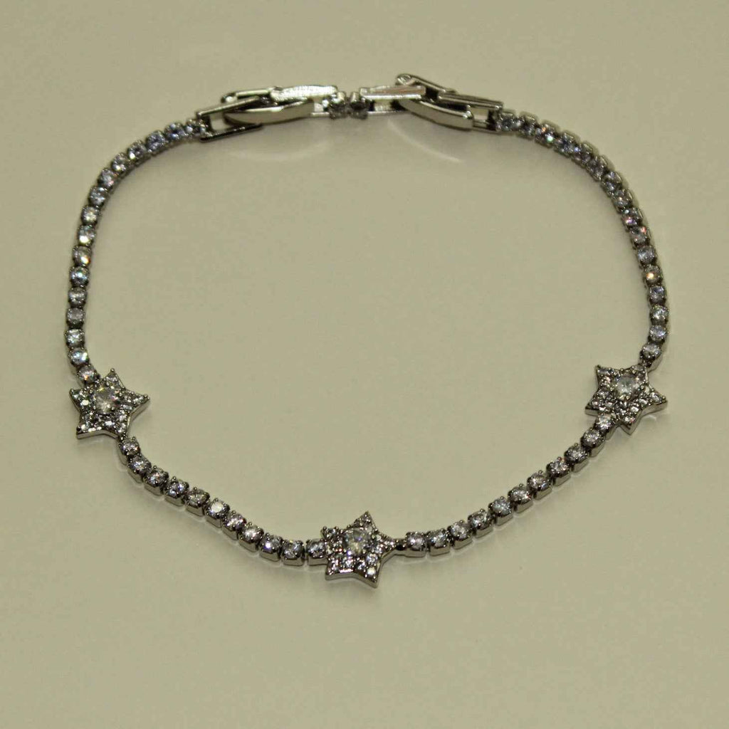 Silver-tone tennis bracelet featuring three clear CZ star accents and stone band