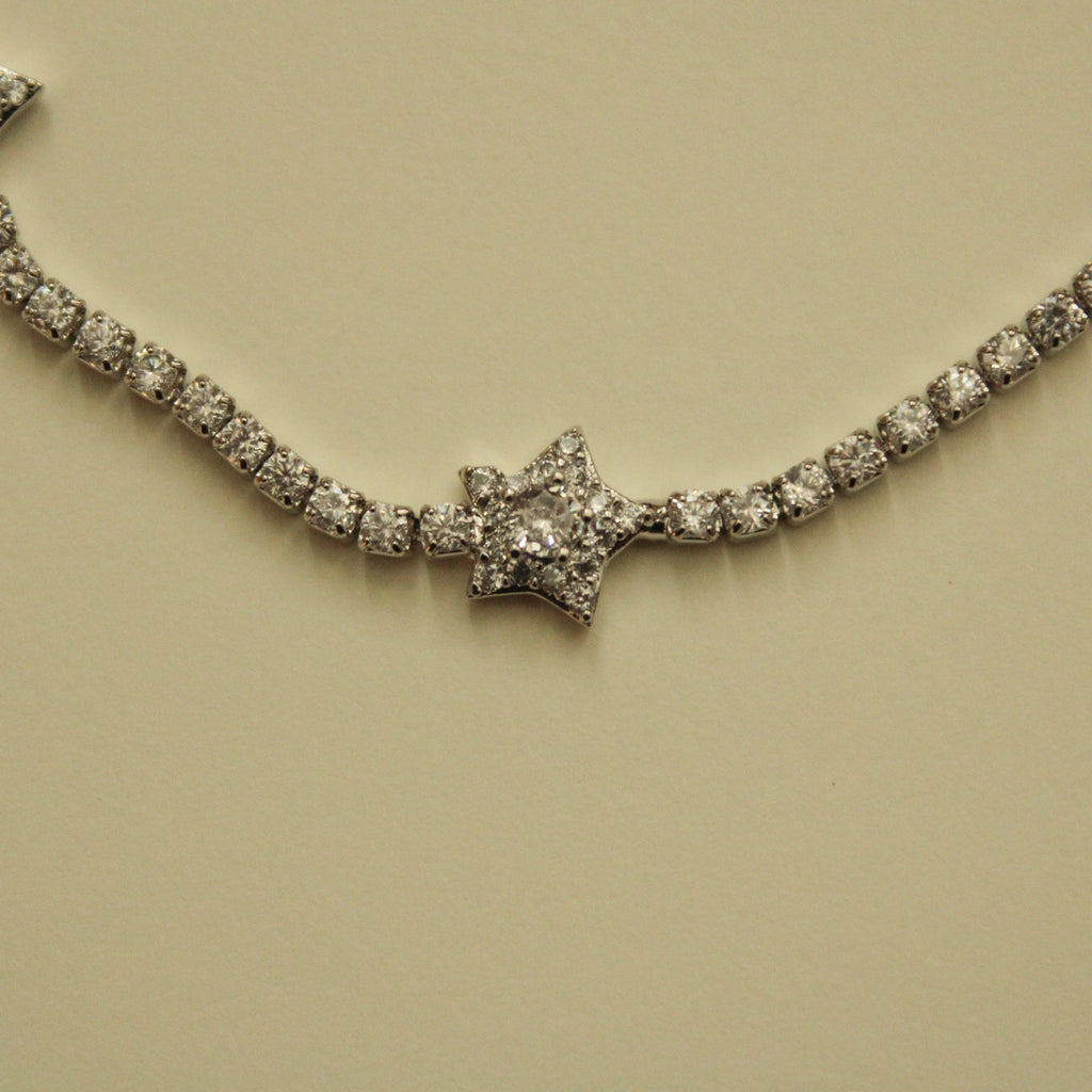 Clear CZ star-studded tennis bracelet with arcing row of sparkling stones