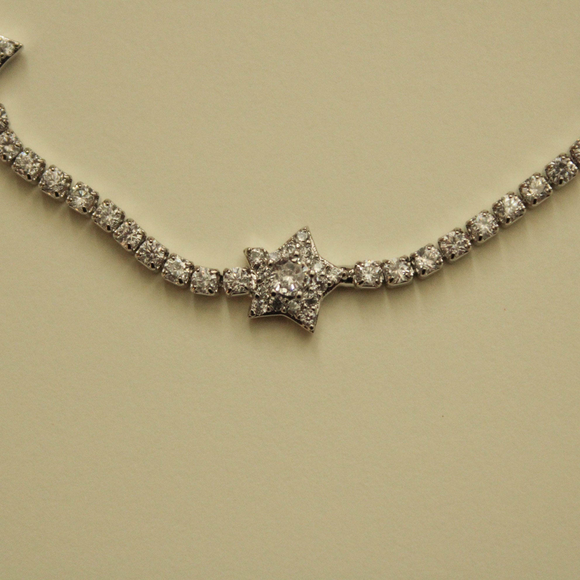 Clear CZ star-studded tennis bracelet with arcing row of sparkling stones