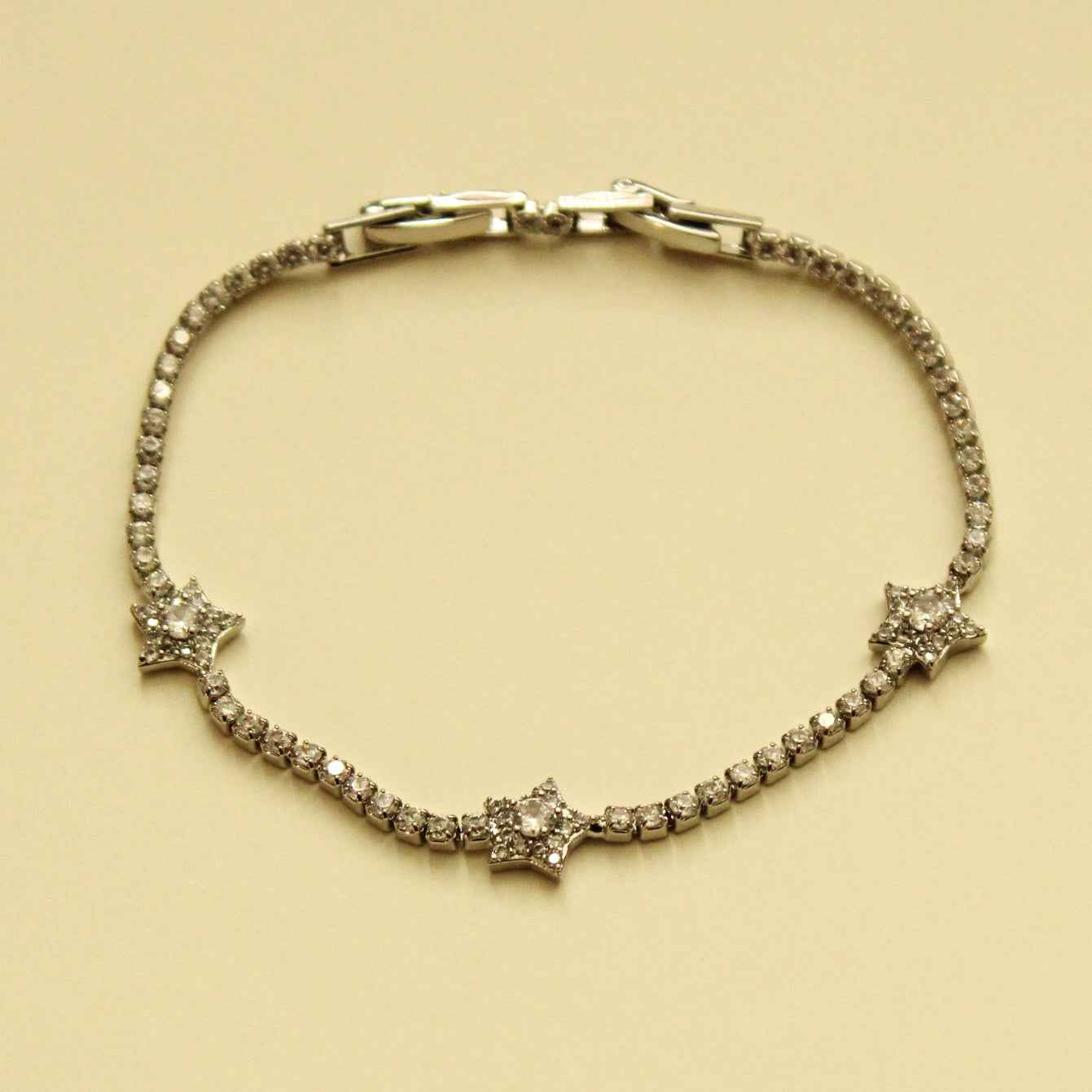Silver-tone clear CZ star tennis bracelet with hinged link closure