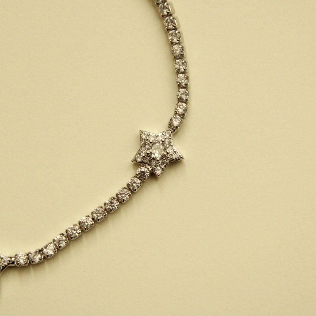Silver-tone tennis bracelet with clear CZ star charms and continuous stone row