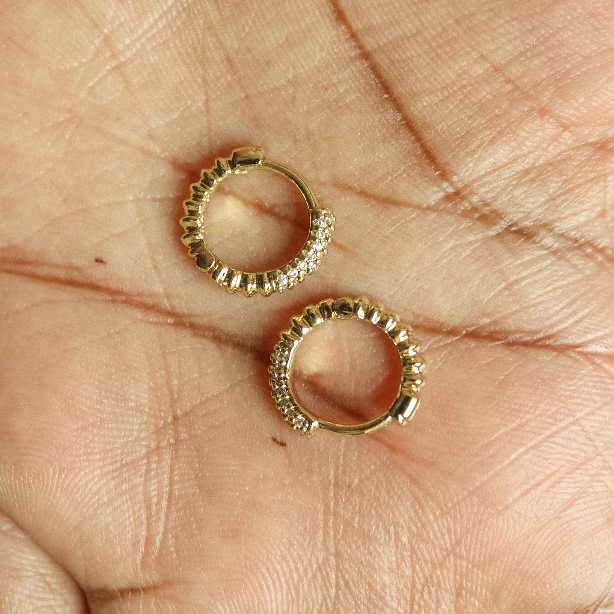 Gold pavé CZ huggie hoop earrings, shown as a small pair